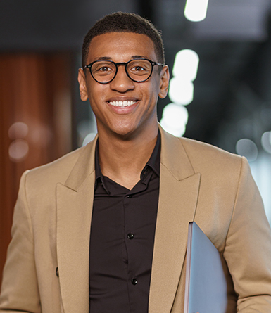 Handsome smiling african businessman with documents standing in modern coworking. High quality photo